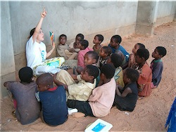 Children participate in informal class with American volunteer.